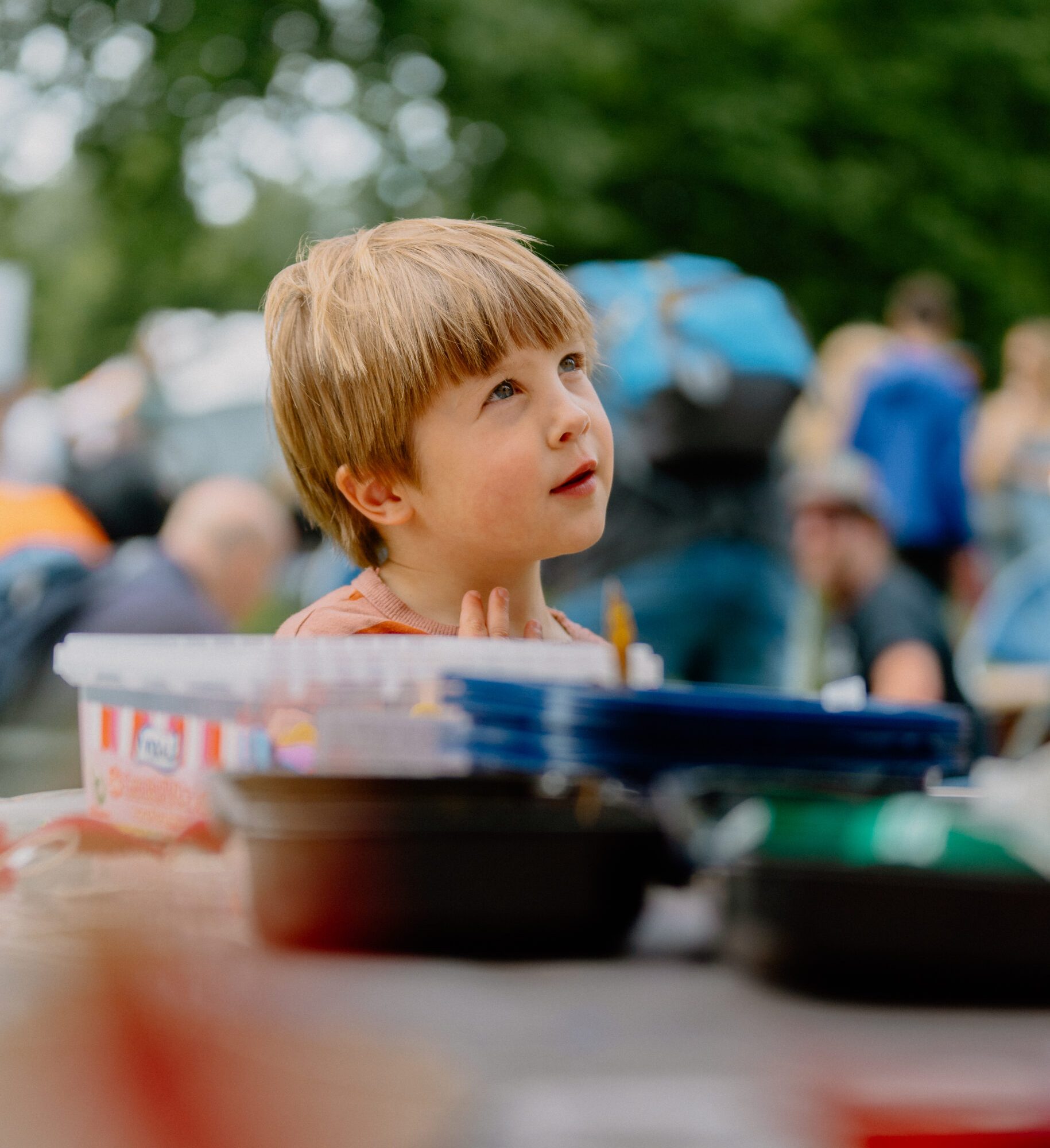 young child standing by an arts and craft table at Exeter Respect Festival