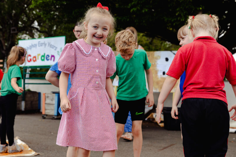school child taking part in a workshop in the school playground
